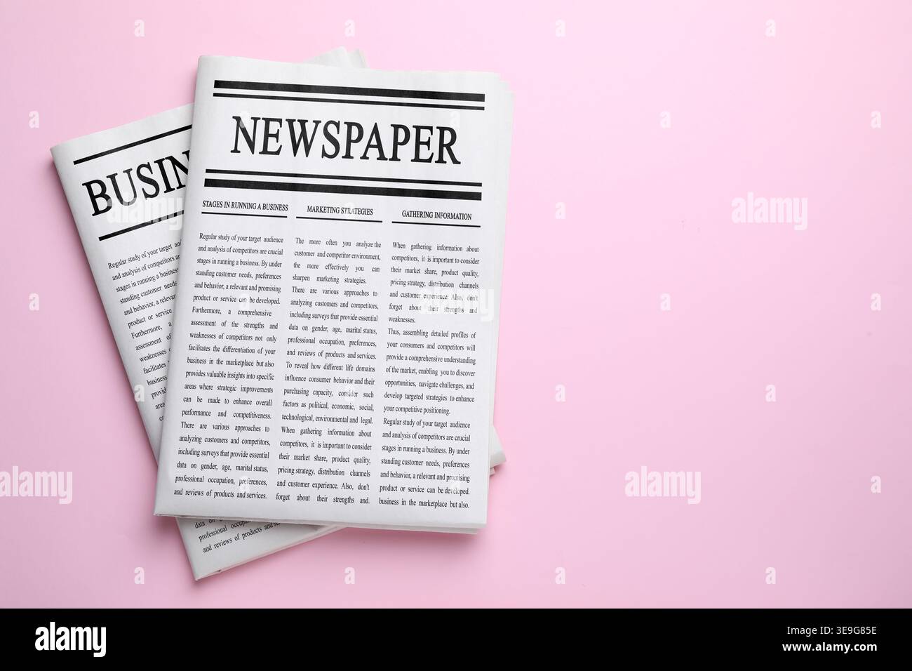 Folded newspapers on pink background, top view Stock Photo