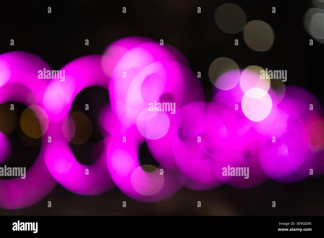 Abstract pink bokeh lights on dark background Stock Photo