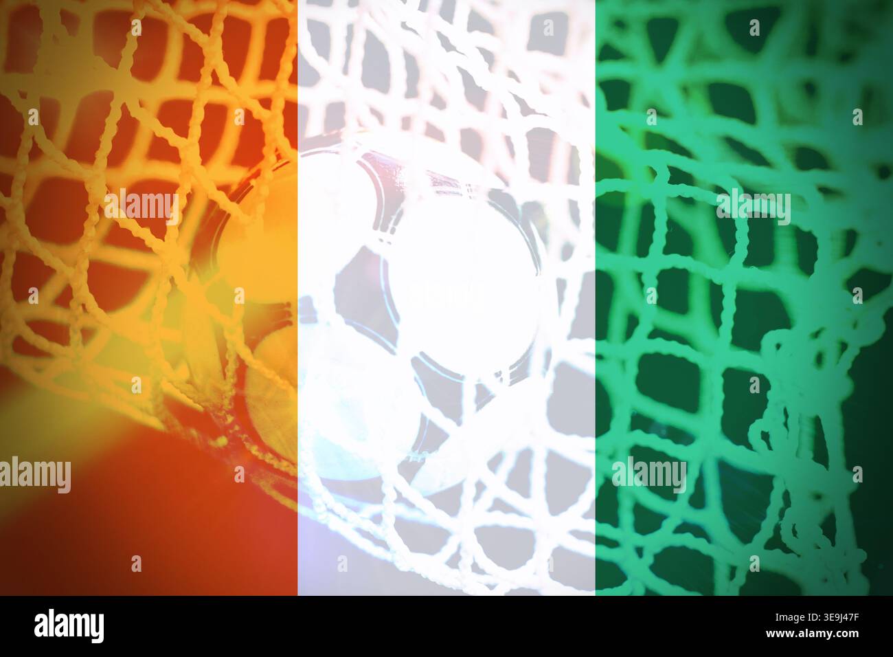 High quality illustration of a soccer ball scoring a goal with the national flag of Ivory Coast in the background. Dynamic sports concept representing Stock Photo