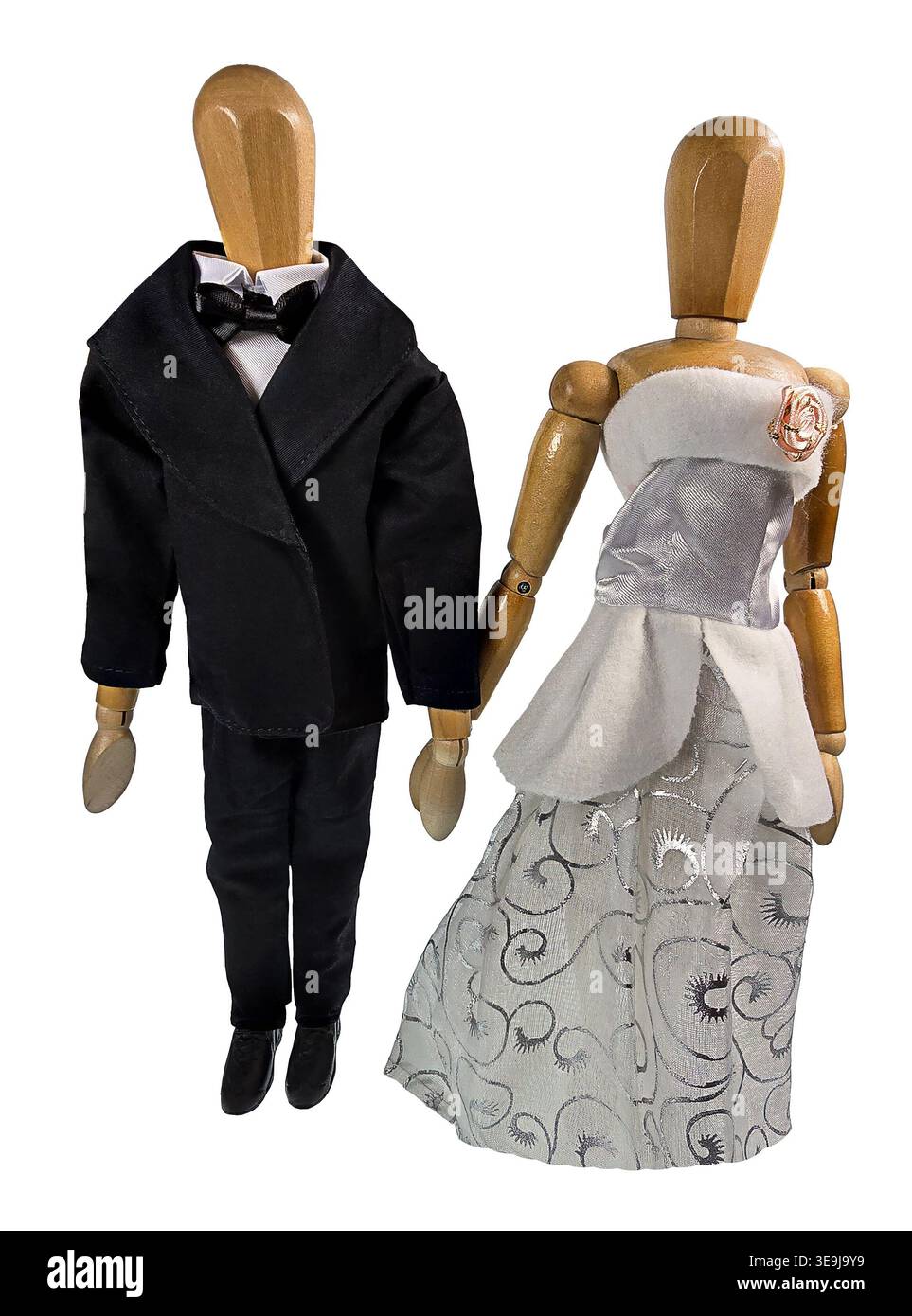 Bride and groom holding hands as they pose for pictures facing the camera Stock Photo