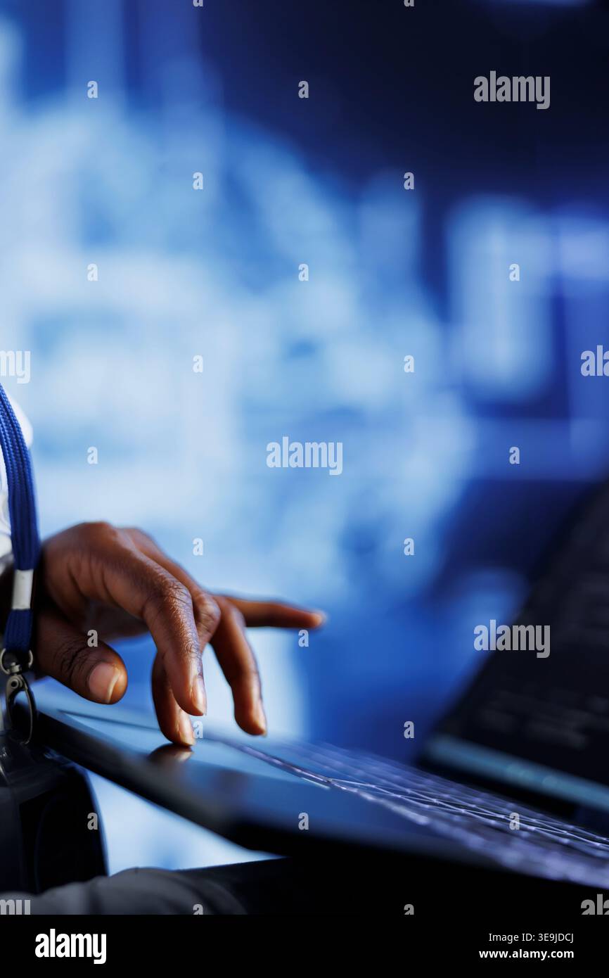 IT consultant writes code on tablet to visualize artificial intelligence neural networks using augmented reality, close up. High tech establishment manager runs AI script for information processing Stock Photo