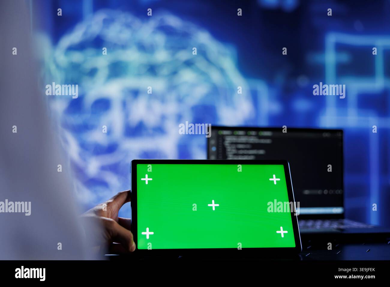 Trained admin writes code on mockup tablet to visualize artificial intelligence neural networks using augmented reality. High tech workspace worker runs AI script on isolated screen device Stock Photo