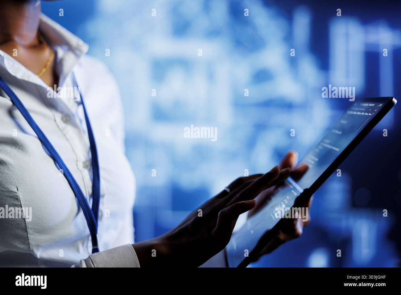 BIPOC computer operator writes code on tablet to visualize artificial intelligence neural networks using augmented reality. High tech workplace executive runs AI script for information processing Stock Photo
