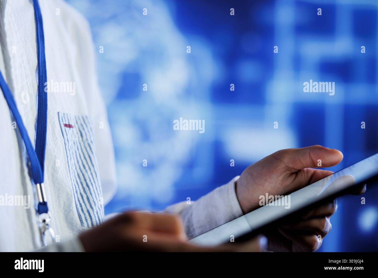 Tech support writes code on tablet to visualize artificial intelligence neural networks using augmented reality, close up. Data center facility worker runs AI script for information processing Stock Photo