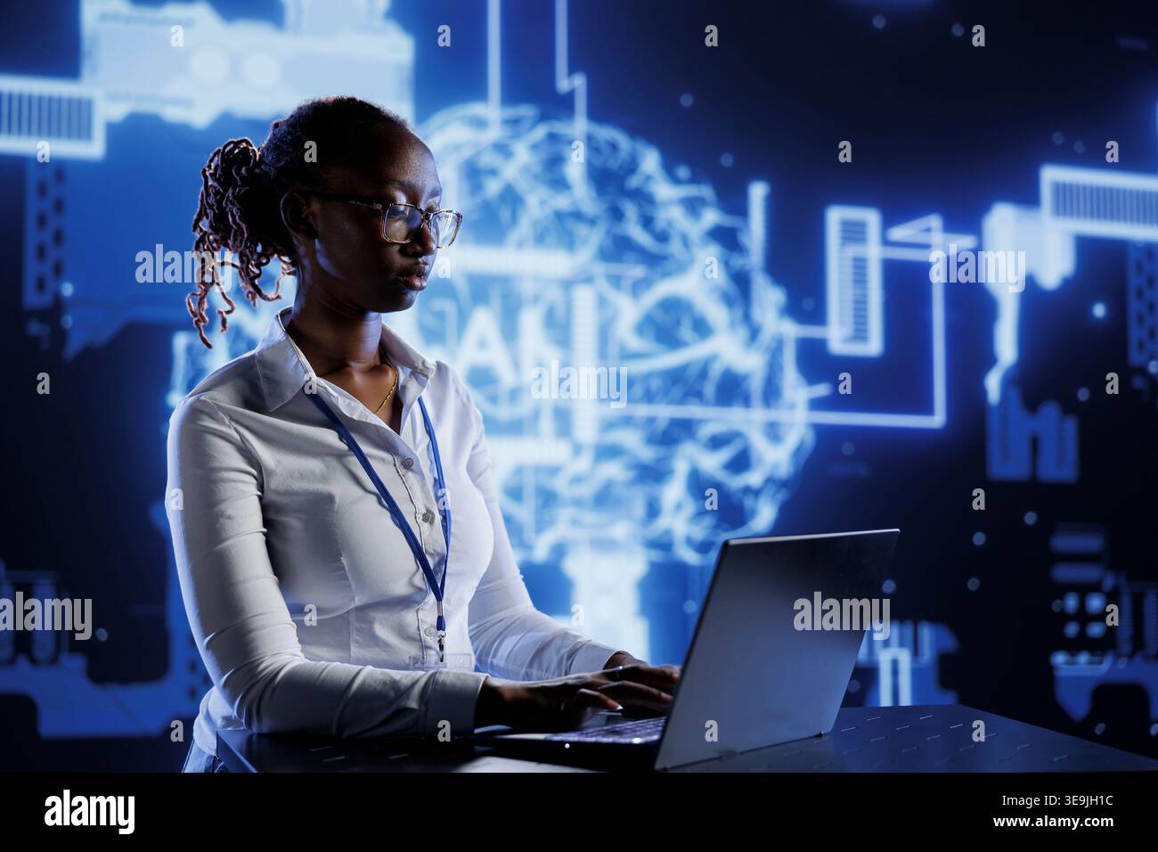 BIPOC woman developing artificial intelligence neural networks architecture inspired by human brain. Tech support setting up AI machine learning algorithms in high tech startup Stock Photo