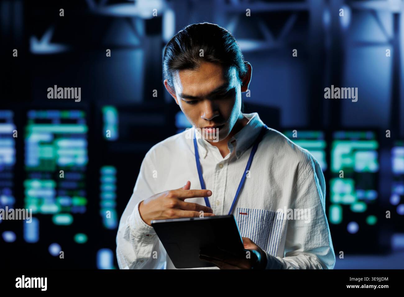 Tech support worker between server hub clusters providing processing resources for businesses worldwide. Overseeing supervisor fixes data center mainframes used for managing massive databases Stock Photo