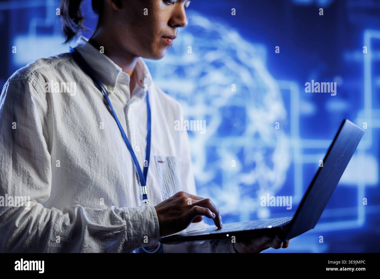 System administrator using laptop to maintenance artificial intelligence neural networks simulating human thought processes in computerized model. Adept professional doing checkup on AI systems Stock Photo