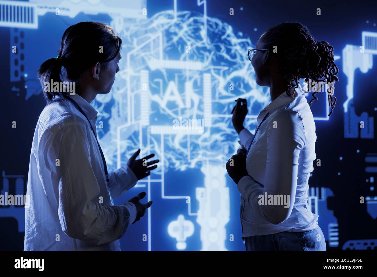 Certified developers brainstorm ways to use AI cognitive computing to extract usable information from complex data. Skilled professionals implement artificial intelligence to process massive datasets Stock Photo