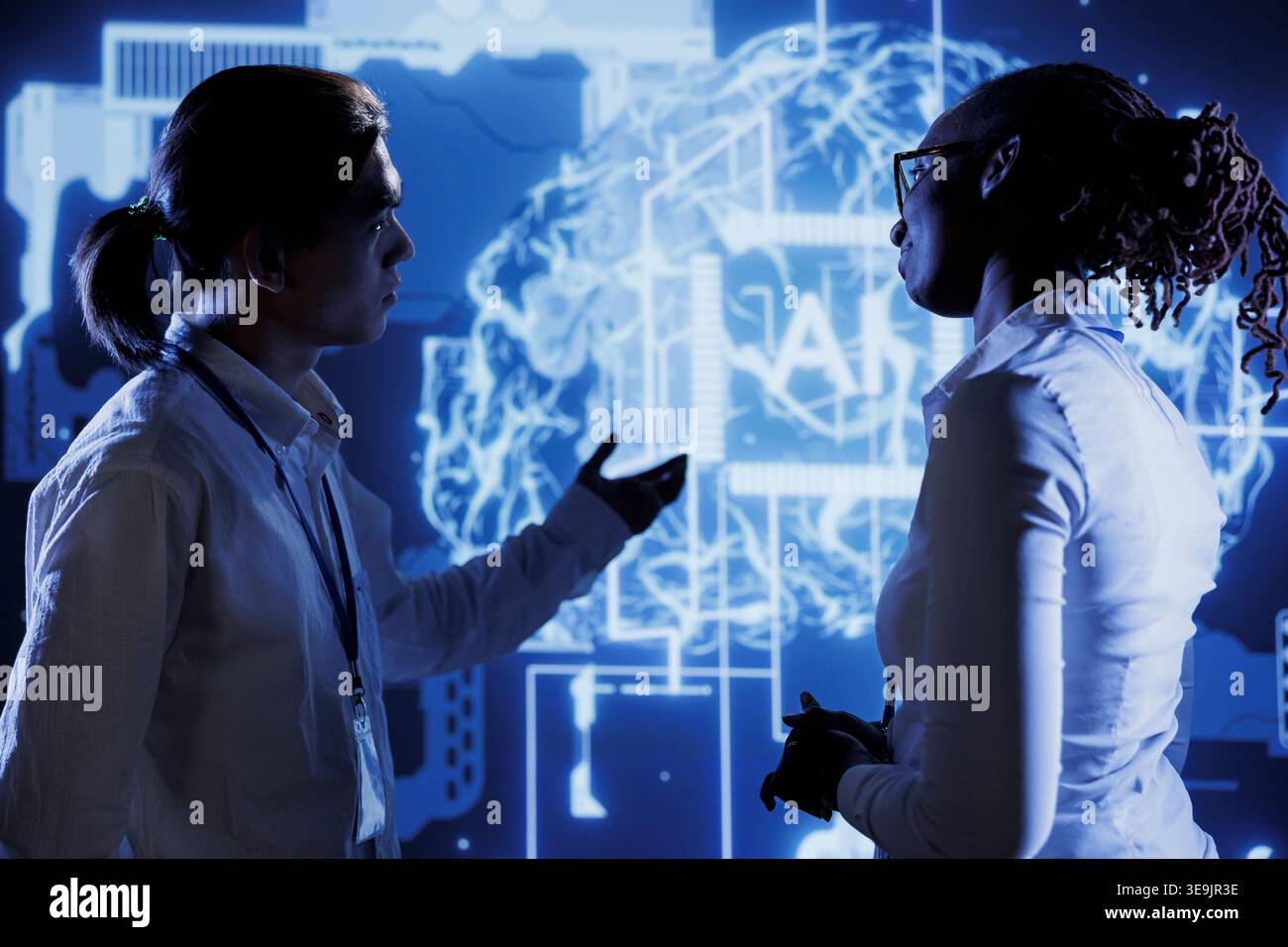 Coworkers brainstorming ways to use AI cognitive computing to extract usable information from complex data. Colleagues implementing artificial intelligence to process massive datasets Stock Photo