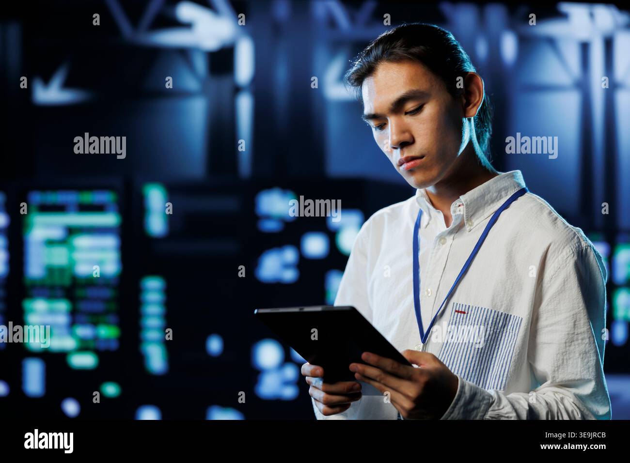 Adept programmer between server hub clusters providing processing resources for businesses worldwide. Overseeing manager fixes data center mainframes tasked with managing massive databases Stock Photo