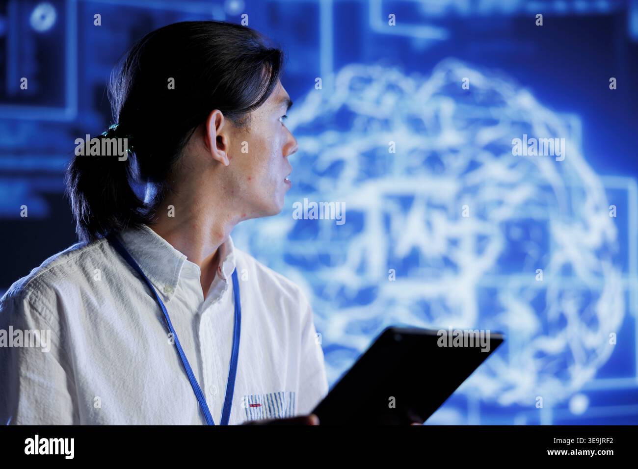 Computer scientist using tablet to maintenance artificial intelligence neural networks simulating human thought processes in computerized model. Tech support doing checkup on AI systems Stock Photo