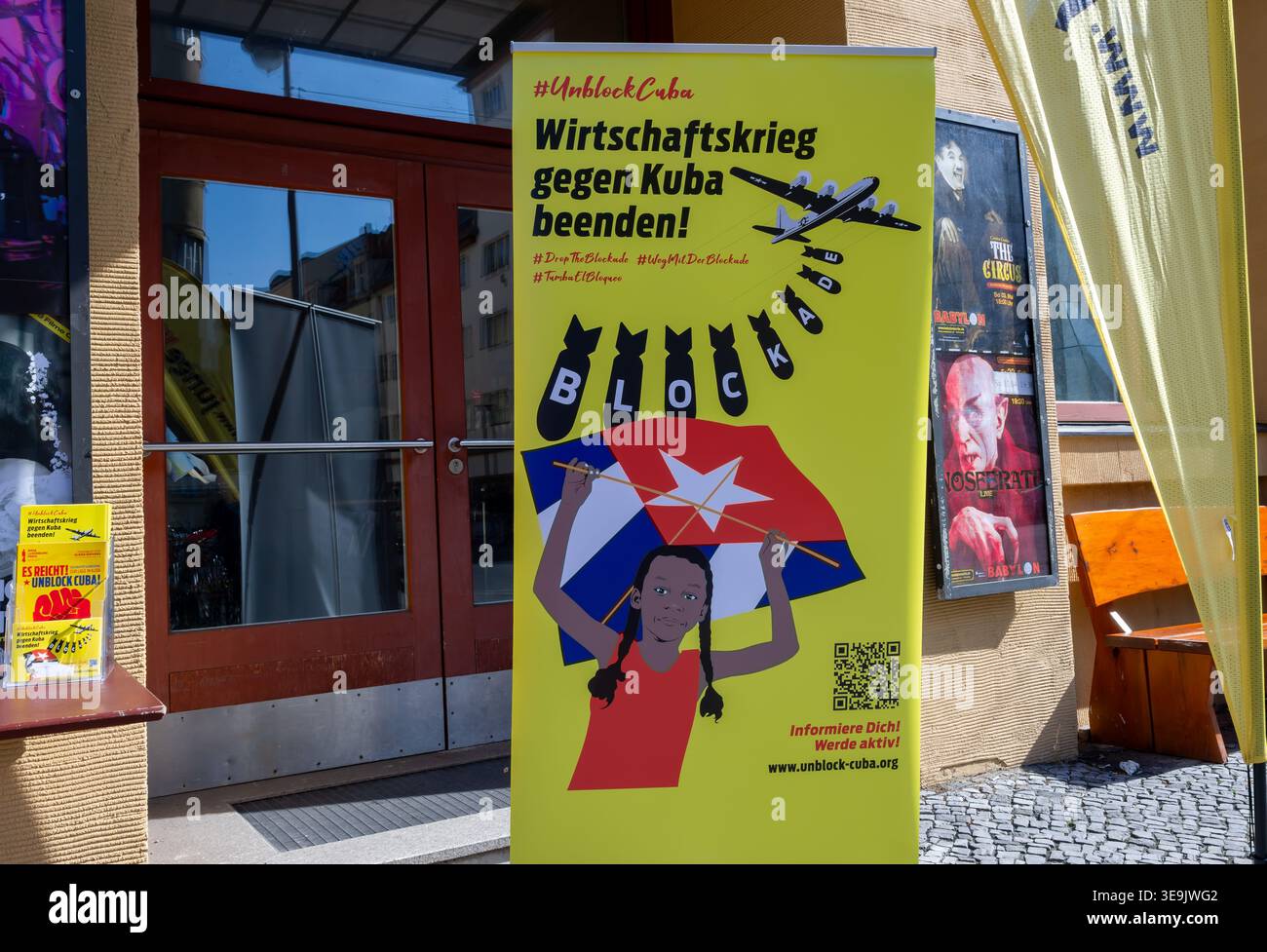 Political poster reading "End the economic war against Cuba" displayed outside Kino Babylon during a Cuba solidarity rally in Berlin, Germany. Stock Photo