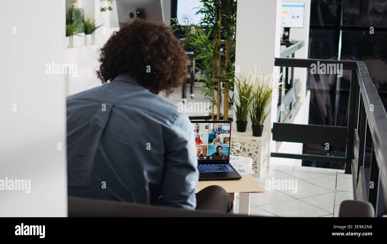 Businessman meeting on videocall with colleagues, presenting new company development vision in agency office. Employee talking on online teleconference remote call, briefing chat. Stock Photo