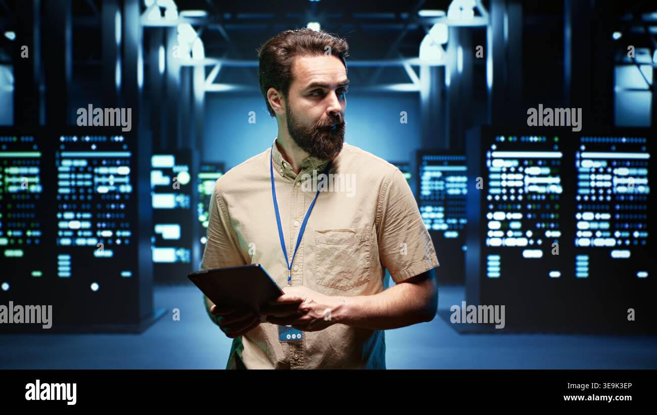 Engineer walking through data center providing computing resources needed for artificial intelligence to process massive datasets for training. Server room storing data used for machine learning Stock Photo