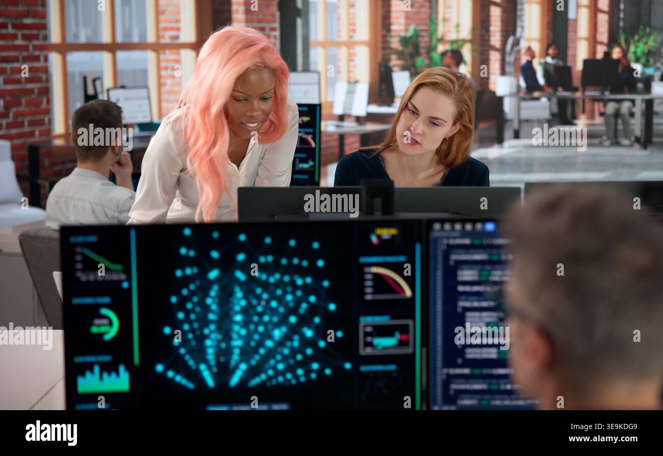 Programmer Collaborates With Diverse Team Analyzing AI Data For Security. Stock Photo