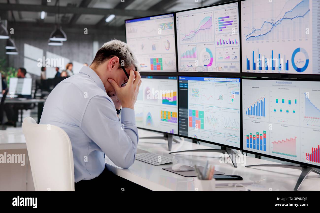 Stressed Business Analyst Struggles With Intricate Data On Computer Screen Stock Photo