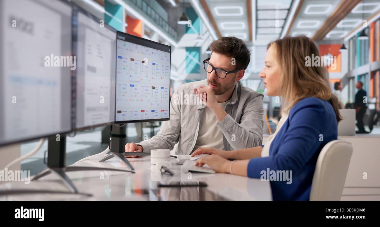 Archivist Diligently Managing Numerous Files On Computer For Cloud-Based Document Solutions Stock Photo