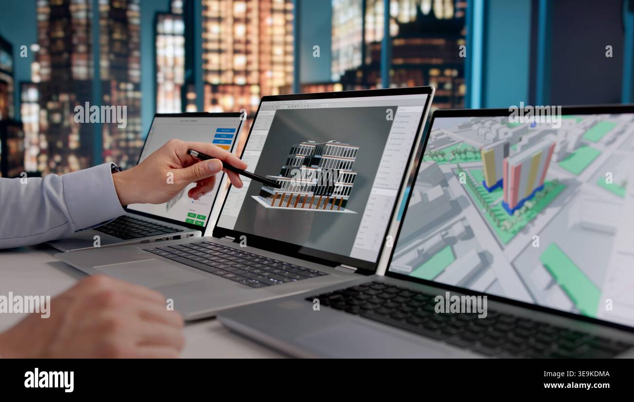 Architect Analyzing 3D BIM Model Designs On Laptop At Night, Engineering And Construction Workflow Stock Photo