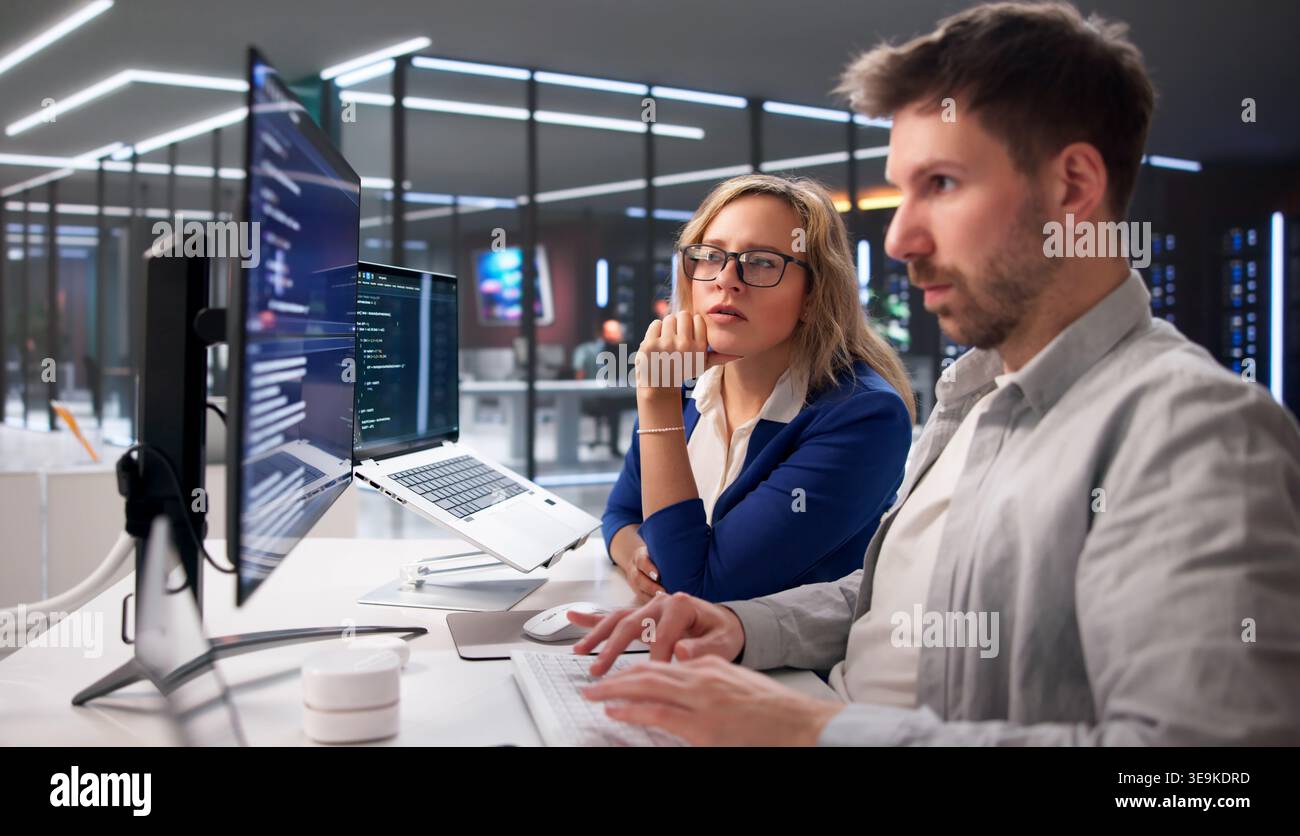 Tech Professionals Collaborating On Coding Projects In Contemporary Workspace Stock Photo