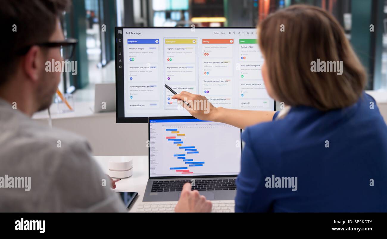 Project Coordinator Diligently Revises Event Timeline With Scrum Tool On Desktop Computer Stock Photo