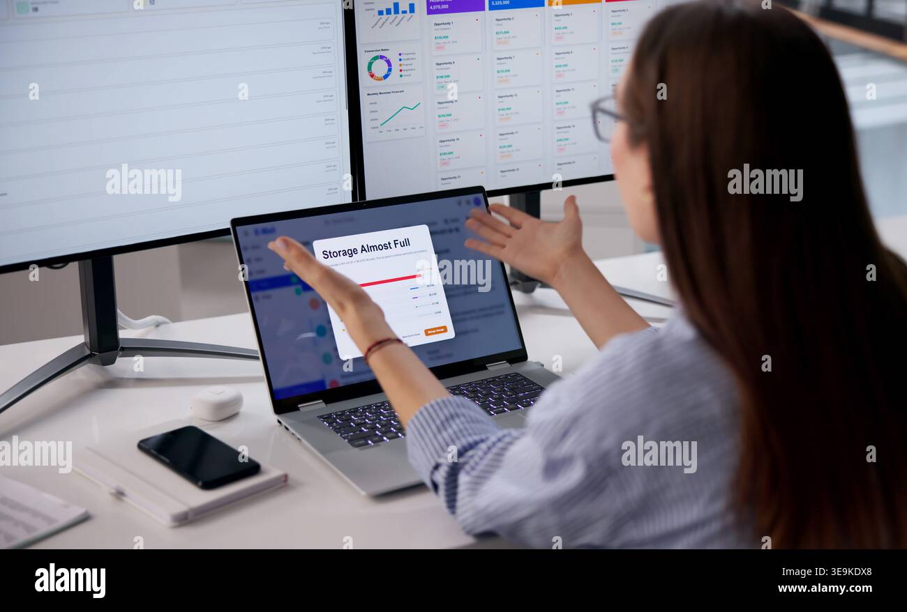Woman Using Laptop Feels Stressed Facing Full Email Storage Problem. Stock Photo