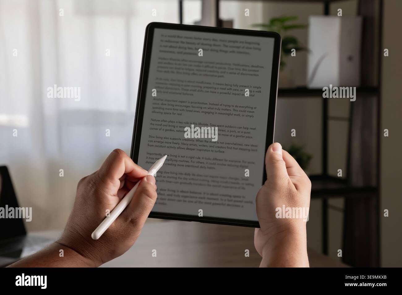 Hands using stylus on tablet displaying text document, writing and editing content for document creation, text processing, content management, and dig Stock Photo