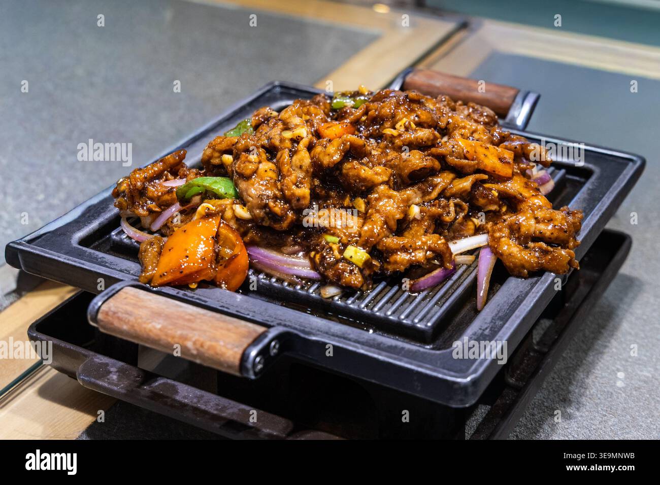 Delicious Chinese lamb with black peppar and cumin served on hot plate Stock Photo