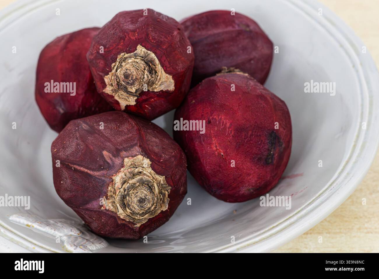 Five peeled beetroots waiting for cooking Stock Photo