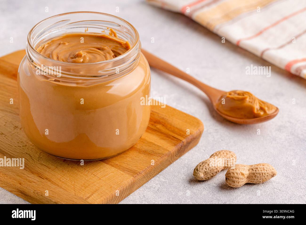 Peanut paste in an open jar Stock Photo