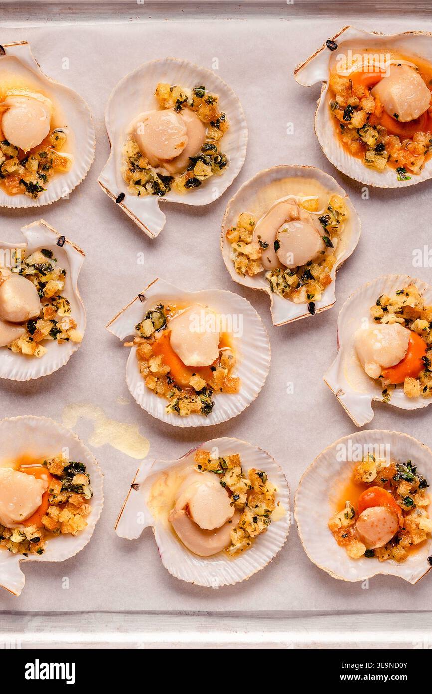 Cooked scallops with sauce on a baking sheet Stock Photo