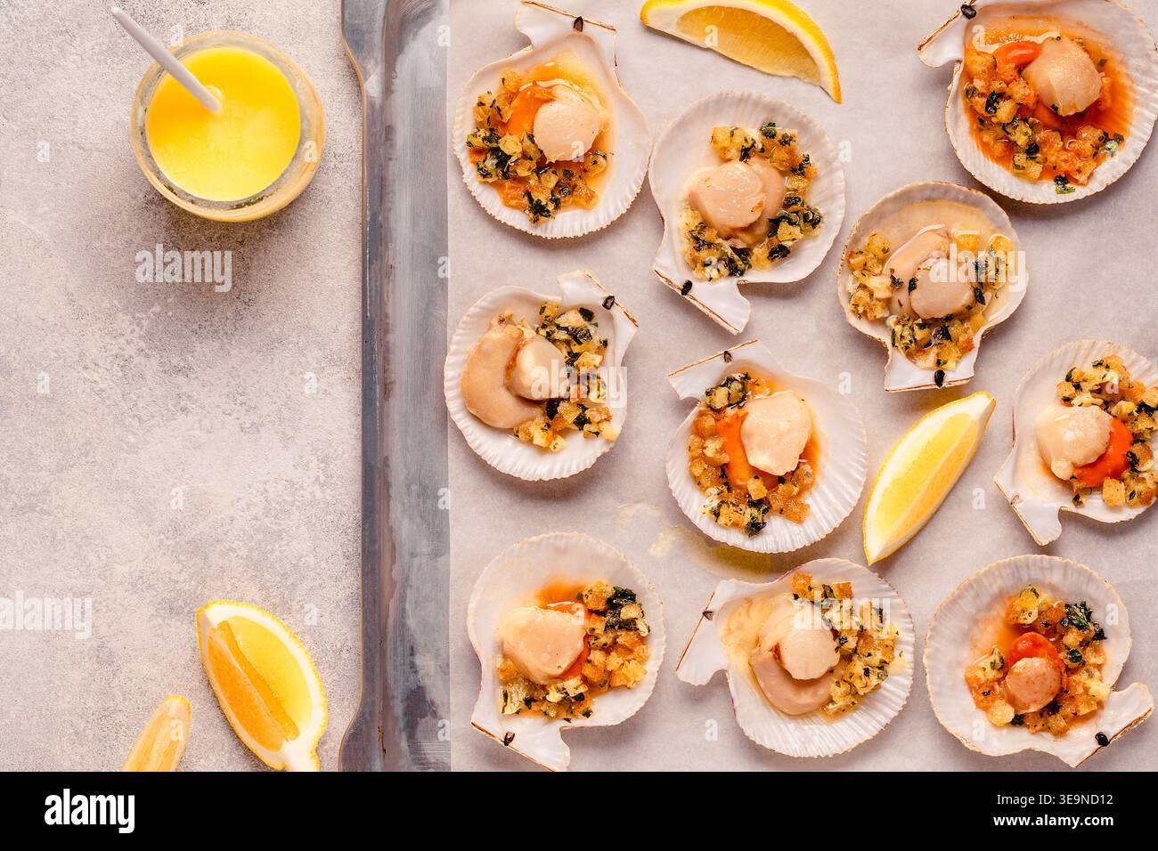 Cooked scallops with sauce on a baking sheet Stock Photo