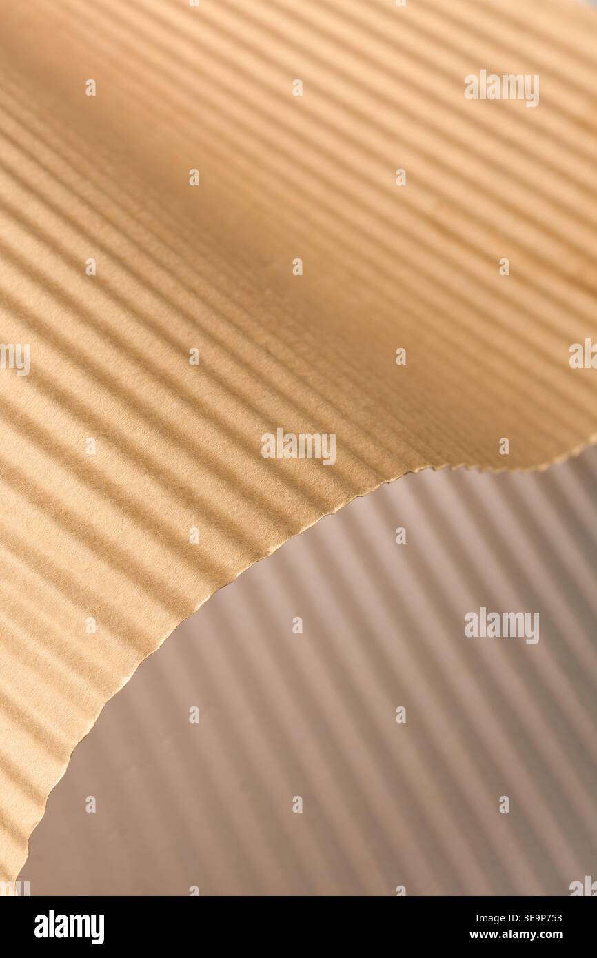 brown corrugated paper sheet with wavy ridges, textured surface with linear pattern, full frame texture, packaging material concept Stock Photo