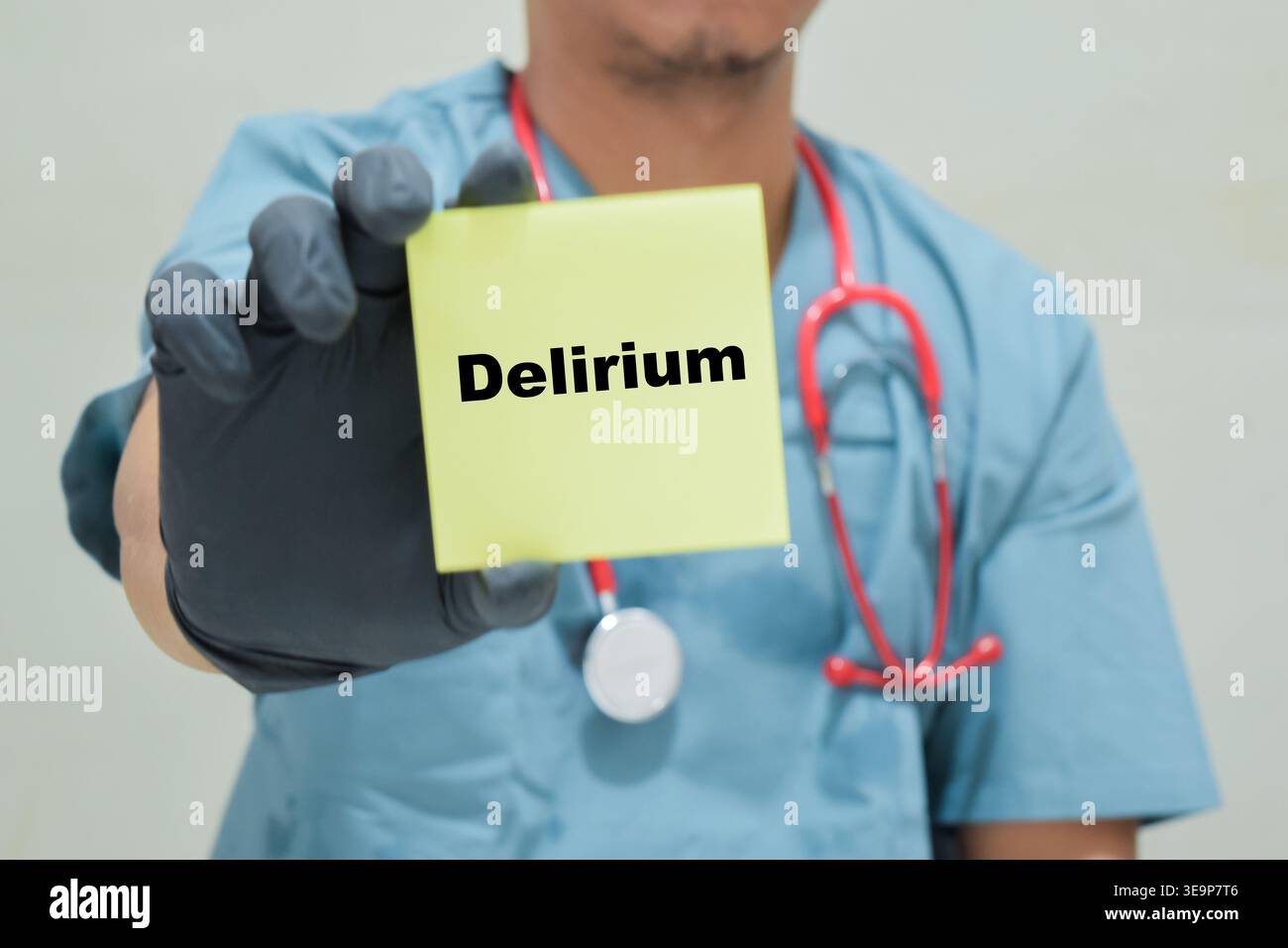 Doctor holds in hands a card with the name of the delirium. Medical concept Stock Photo