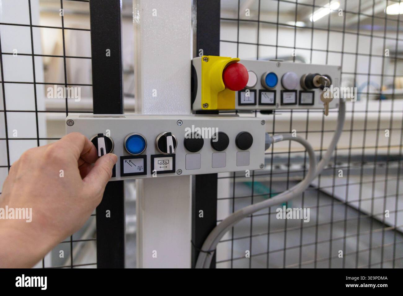 Operator Adjusting Industrial Control Panel in Factory Stock Photo