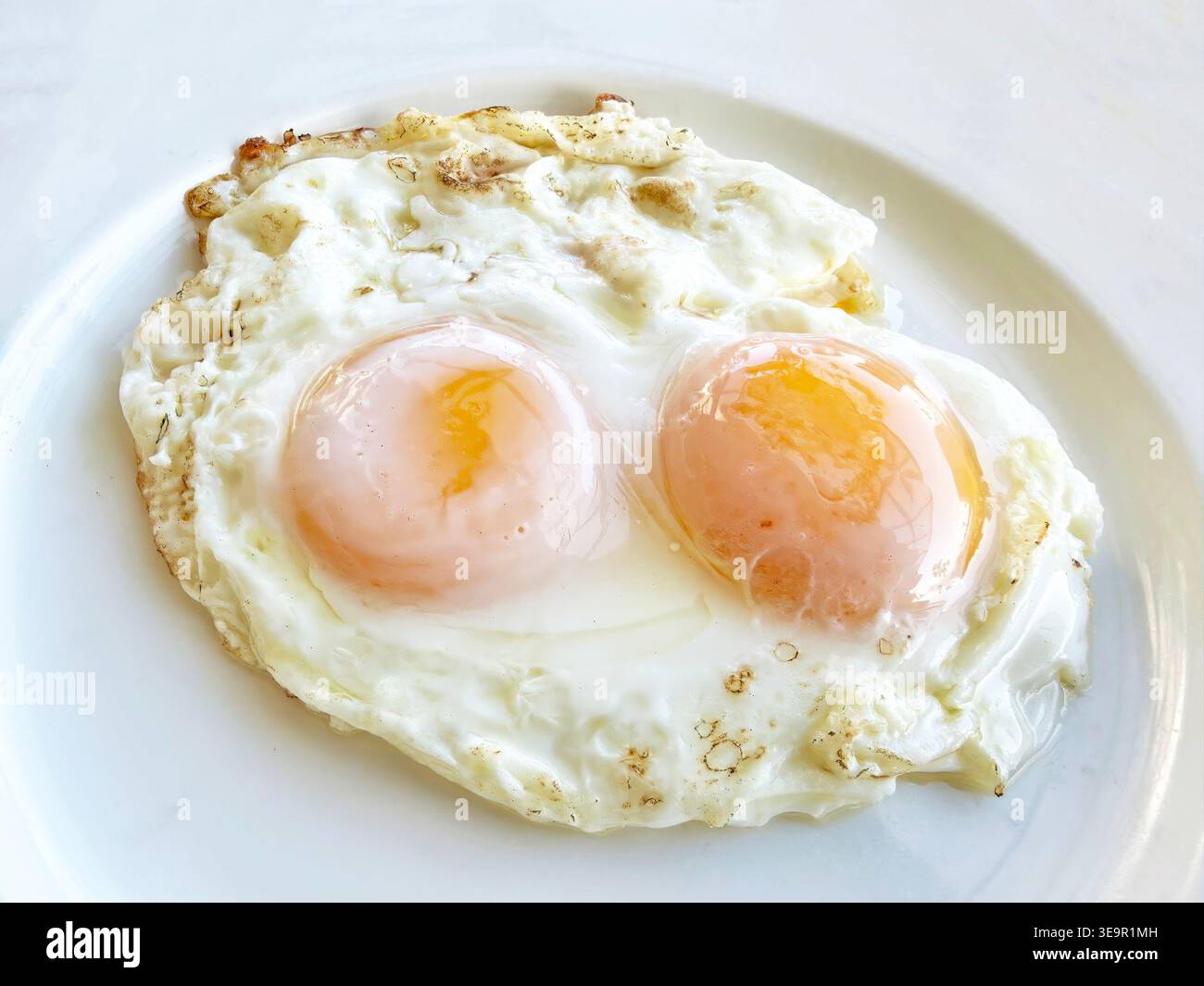 Two fresh fried eggs sunny side up Stock Photo