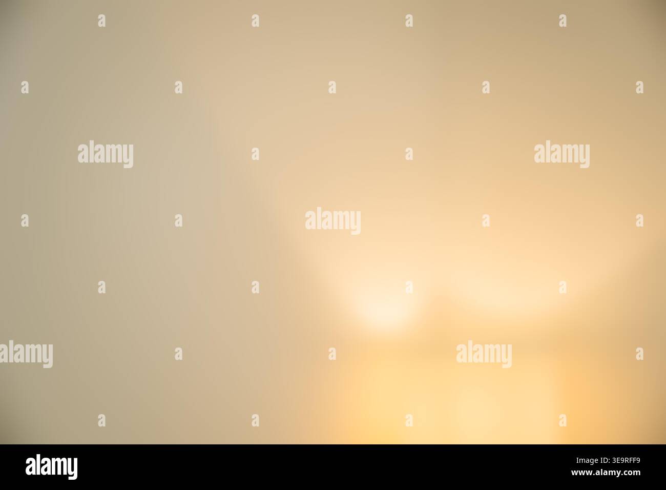 Soft warm gradient bokeh abstract background with golden glow, selective focus Stock Photo
