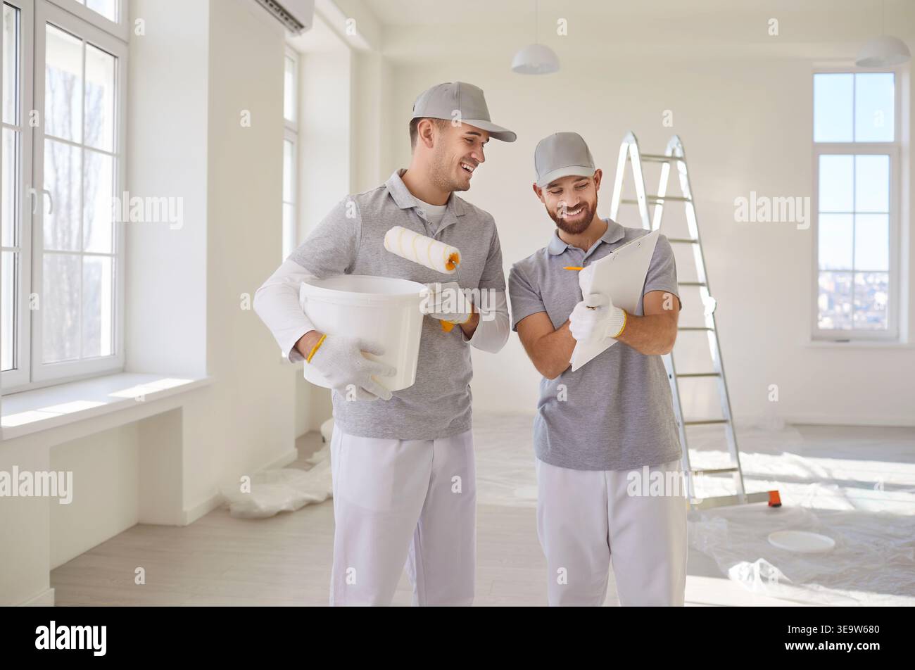 Professional Painters Working On Home Renovation Stock Photo