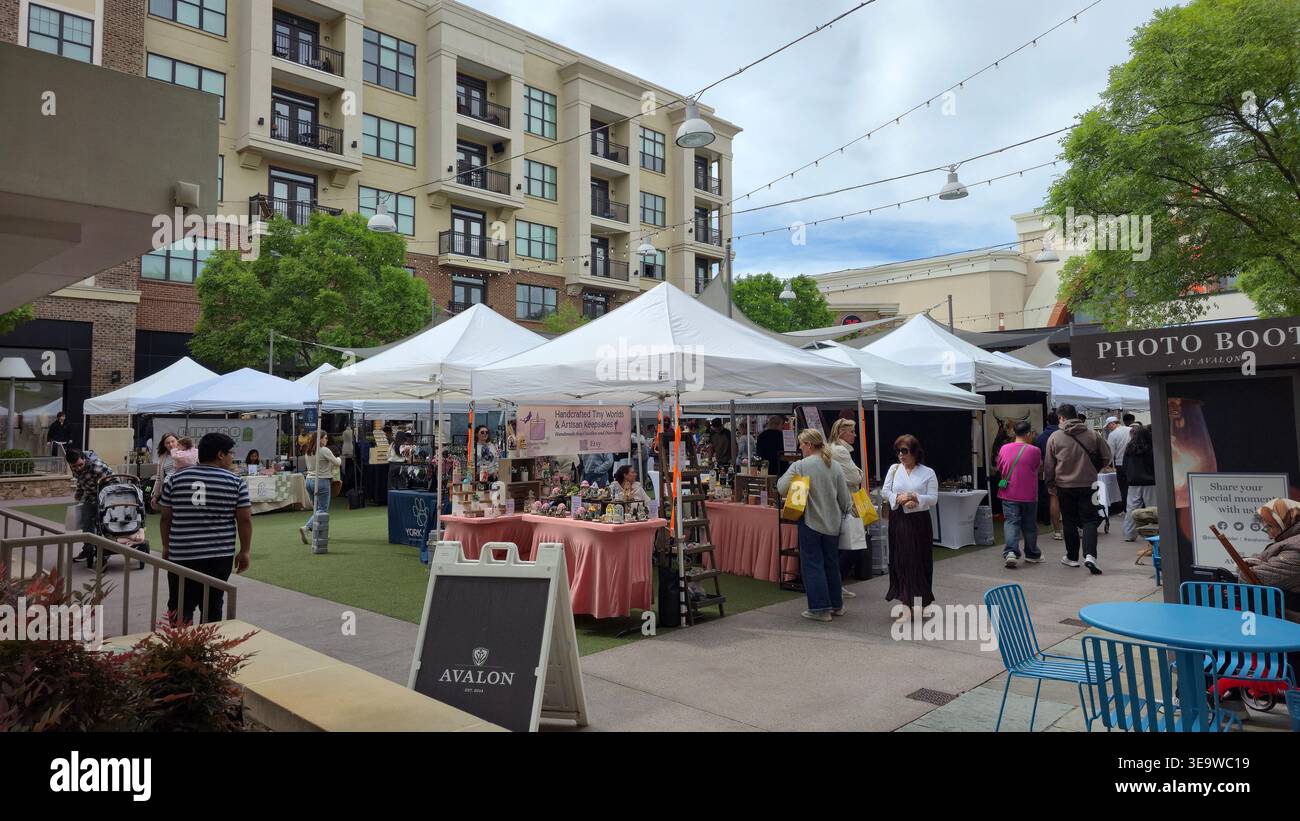Outdoor artisan market at Avalon in Alpharetta, Georgia, USA, with local vendors, tents and visitors shopping at a community fair - Smartphone Captured Stock Image