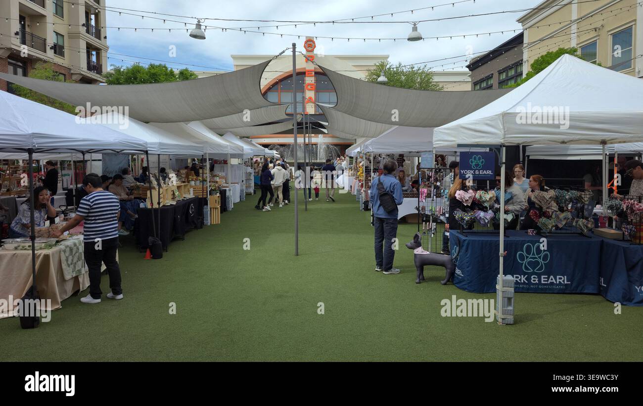 Outdoor artisan market at Avalon in Alpharetta, Georgia, USA, with local vendors, tents and visitors shopping at a community fair - Smartphone Captured Stock Image