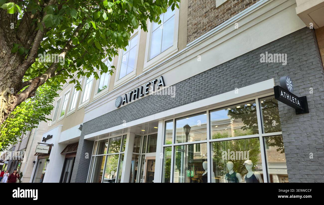 Athleta retail store exterior with brand signage and storefront display in a shopping district at Avalon, Alpharetta, Georgia, USA - Smartphone Captured Stock Image
