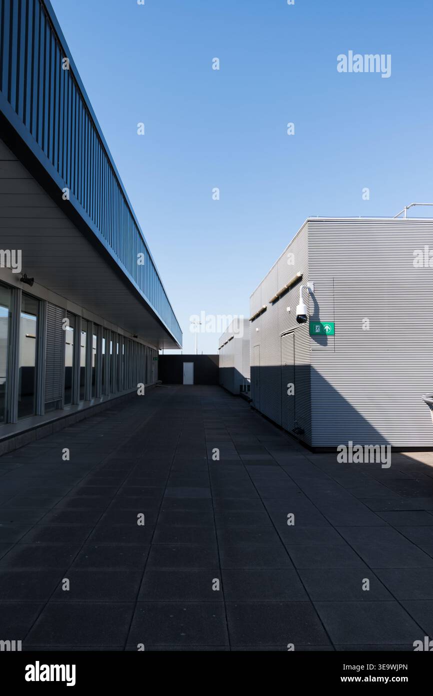 Outdoor service corridor between two industrial terminal buildings at ...