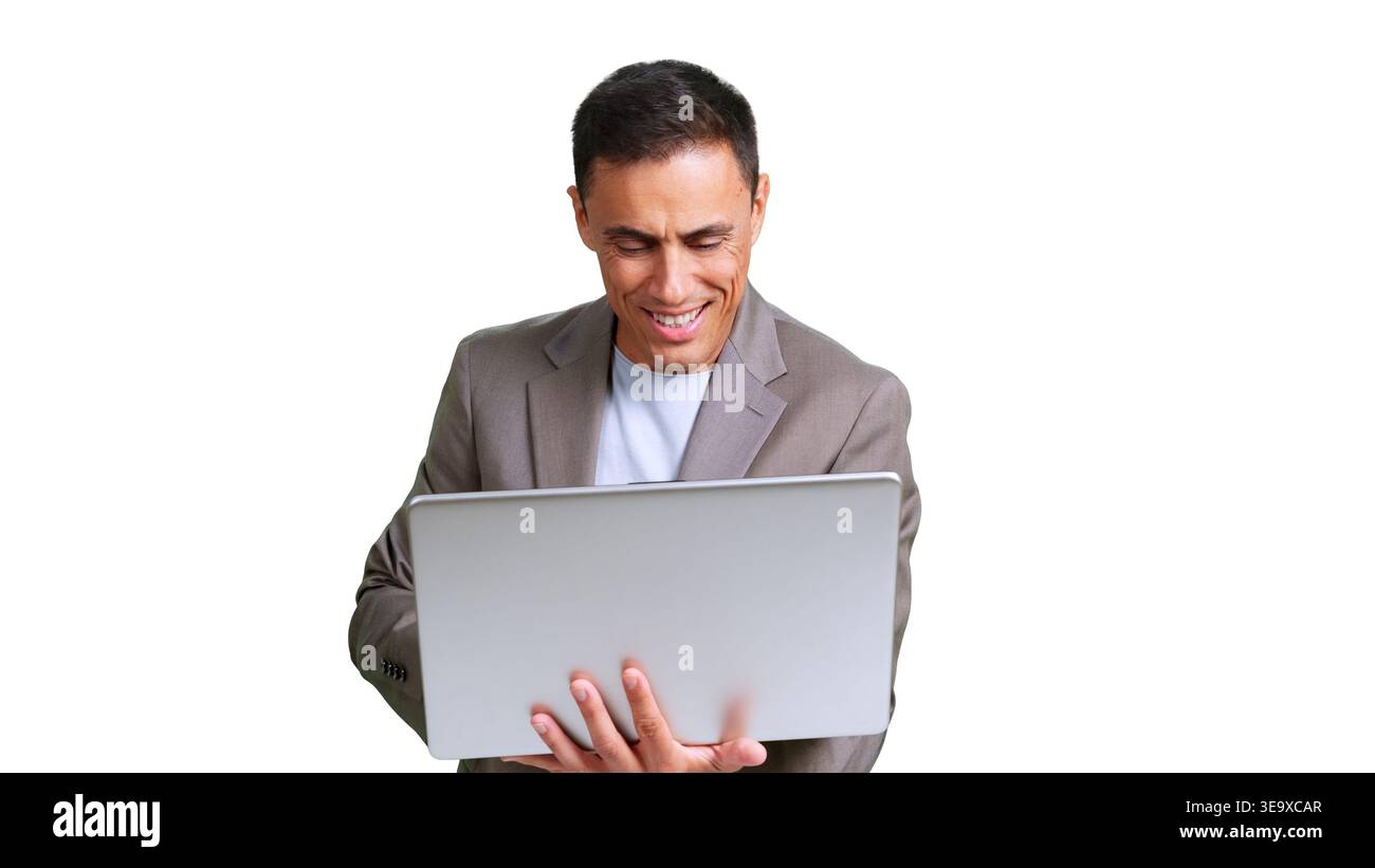 Man smiling and working intently on a laptop computer Stock Photo