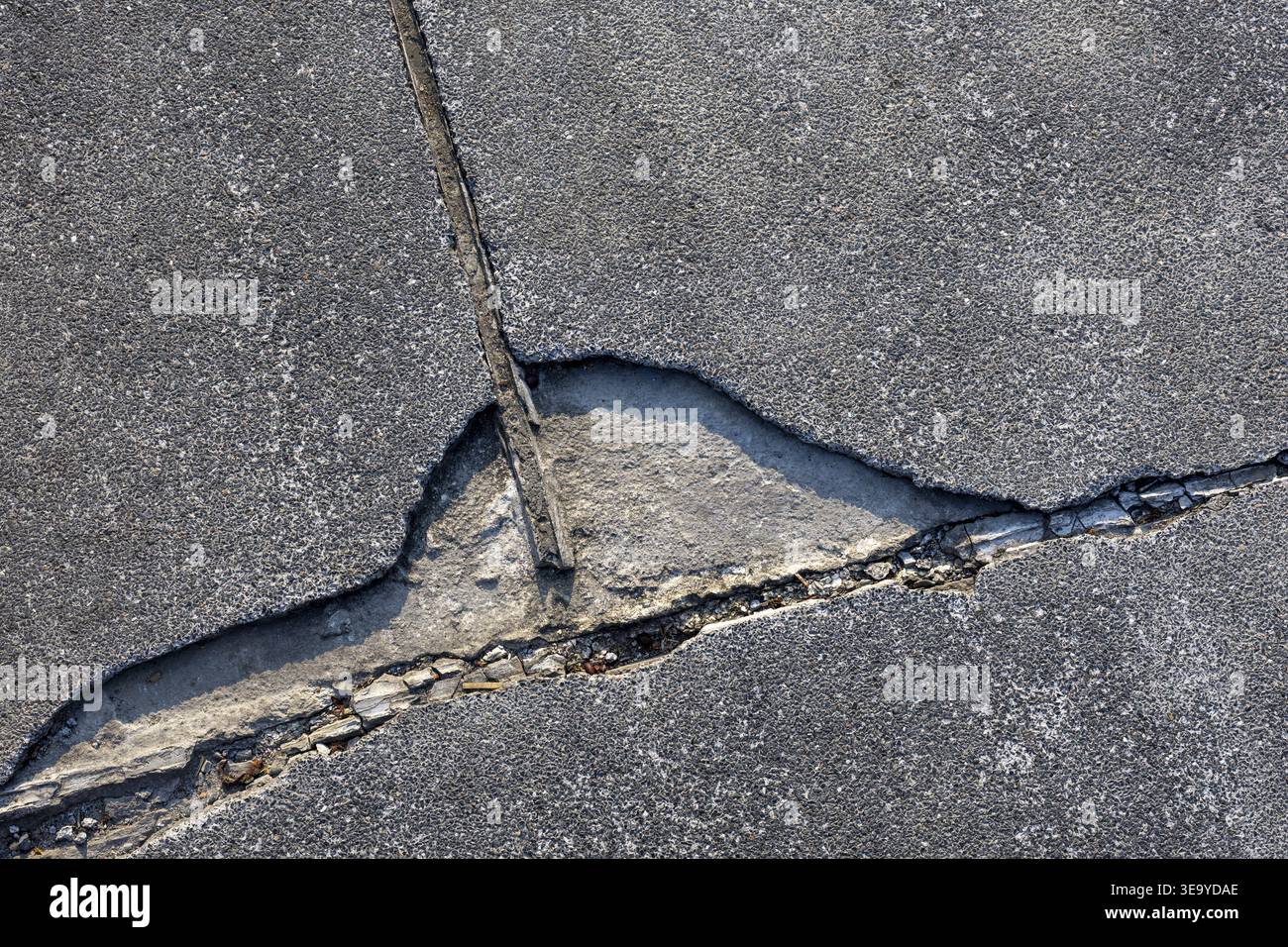 Close up view of severe crack concrete asphalt showing extensive damage ...