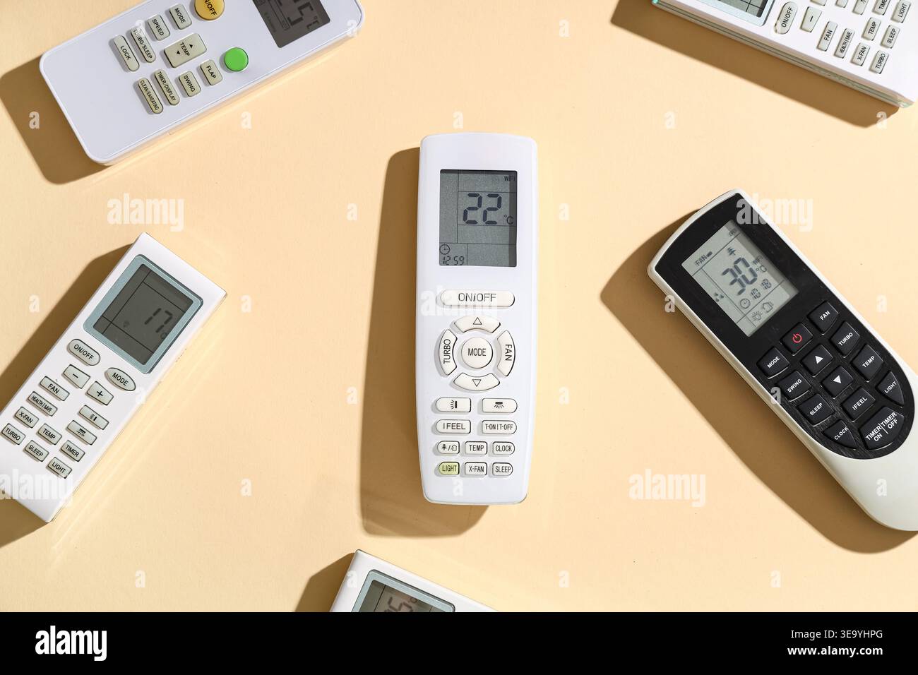 Air conditioner remote controls on beige background Stock Photo