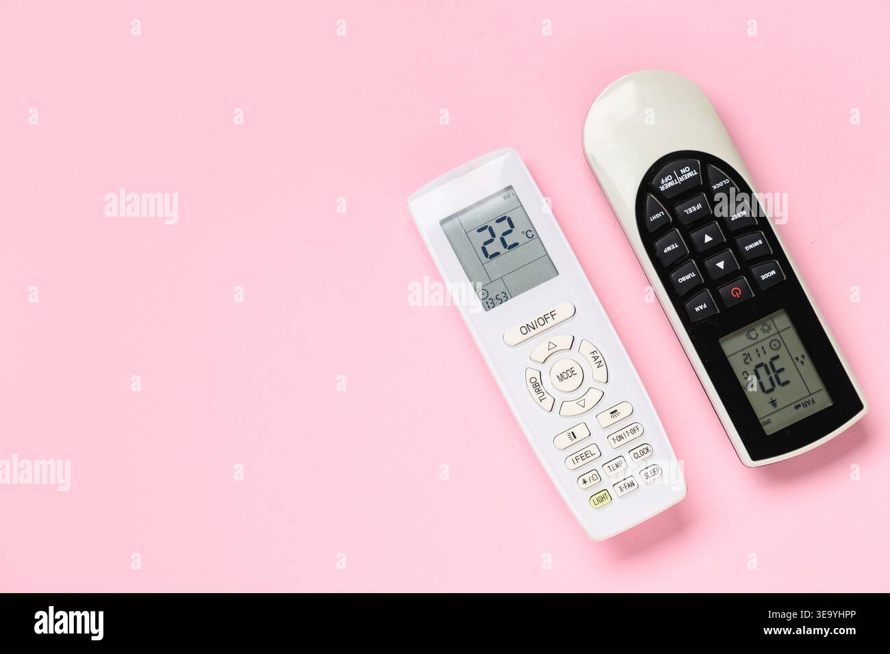 Air conditioner remote controls on pink background Stock Photo