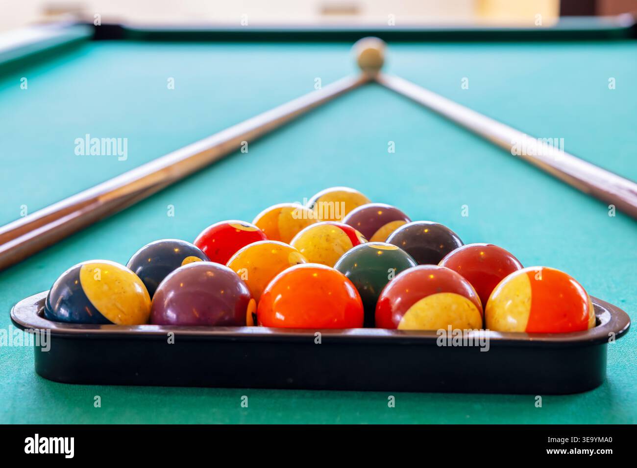 Billiard balls in triangle and cues on table. Selective focus Stock Photo