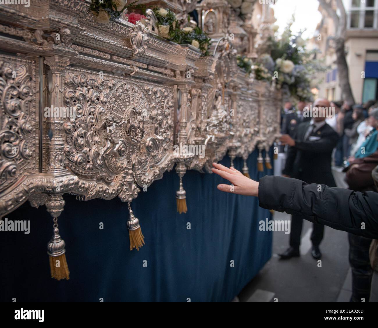 Processional Float Devotional gesture beside silver processional float during Holy Week ...