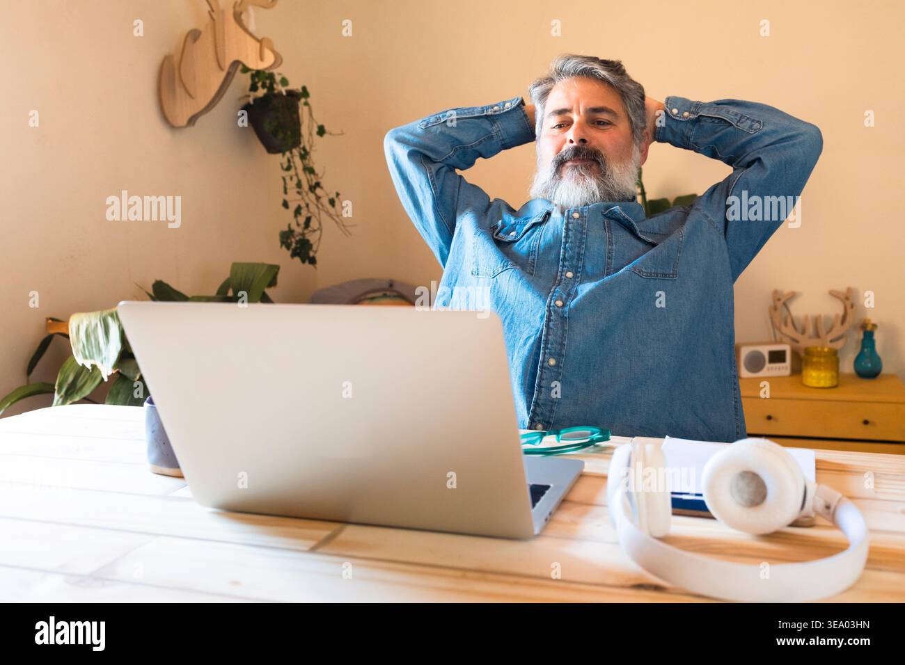 Mature man relaxing at home while taking a work break Stock Photo
