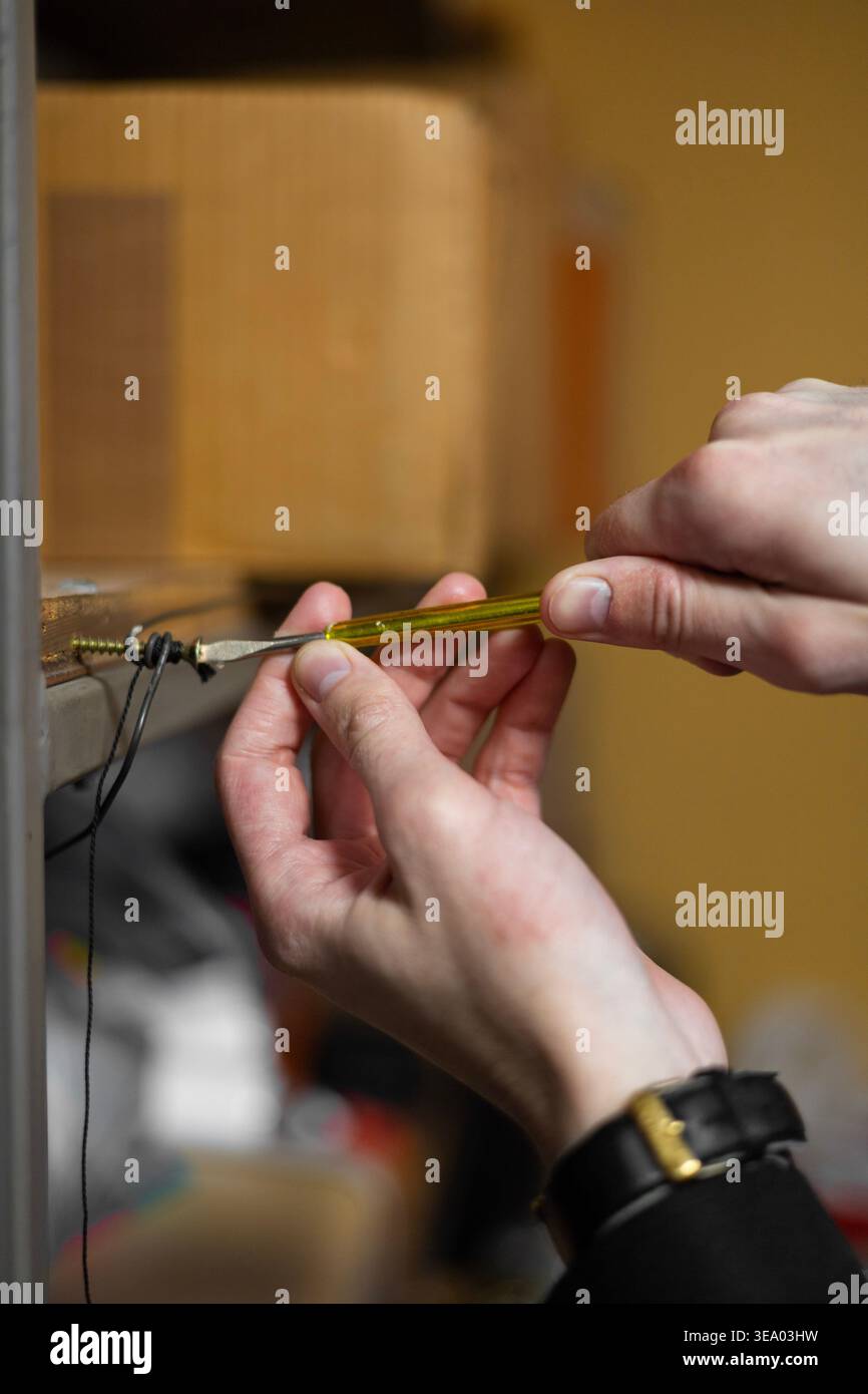 male hands using a small screwdriver Stock Photo