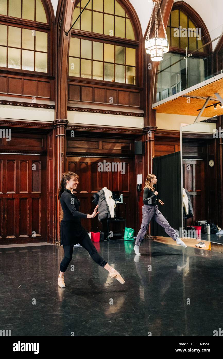 Young ballerinas practicing ballet steps in spacious studio Stock Photo